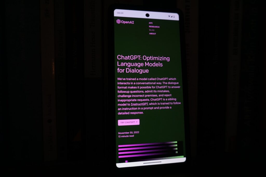a cell phone with a lit up screen in the dark with ChatGPT