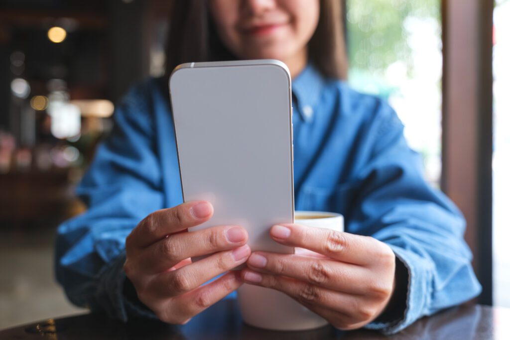 M 2023 11 27 05 30 40 Closeup image of a young woman holding and using UTC