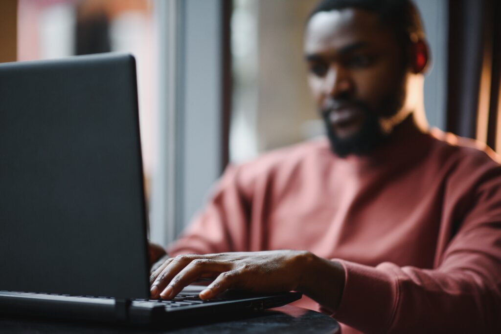 african american man working on laptop in a cafe 2023 12 29 21 20 08 utc